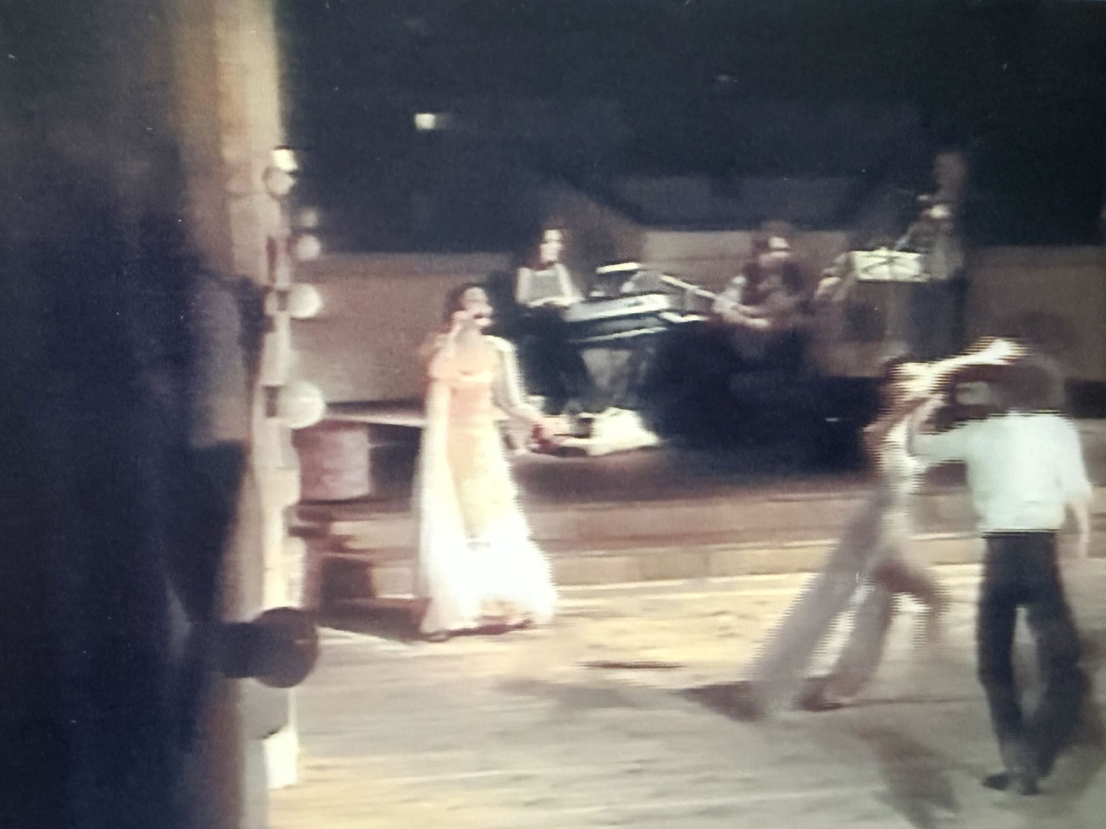 Angela performing outdoors with a live band during her stage career